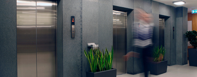 Man walking past elevators